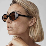 Women’s Oval Sunglasses with Black Frame and Brown Lenses